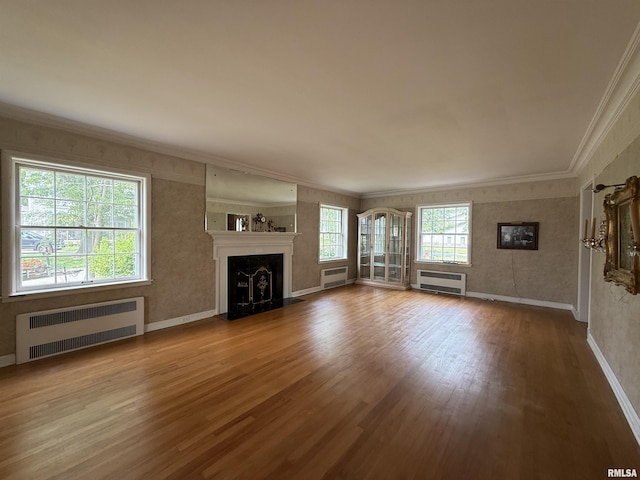 215 3rd St, Carmi, IL 62821 - unfurnished living room with radiator, ornamental molding, wood finished floors, baseboards, and a fireplace
