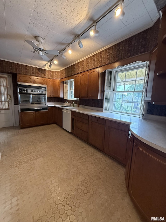 215 3rd St, Carmi, IL 62821 - kitchen with track lighting, dishwasher, oven, wallpapered walls, and ceiling fan
