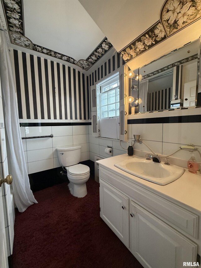 215 3rd St, Carmi, IL 62821 - full bathroom featuring tile walls, wallpapered walls, toilet, vanity, and a wainscoted wall