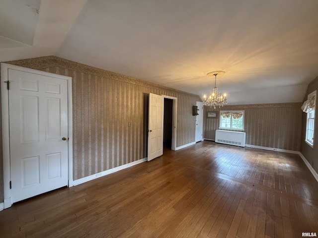 215 3rd St, Carmi, IL 62821 - empty room with a chandelier, hardwood / wood-style flooring, radiator, baseboards, and wallpapered walls