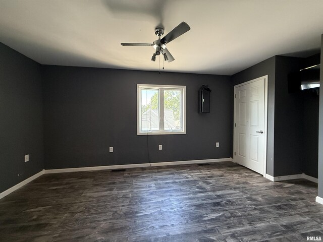 215 3rd St, Carmi, IL 62821 - unfurnished bedroom featuring baseboards, dark wood finished floors, and ceiling fan