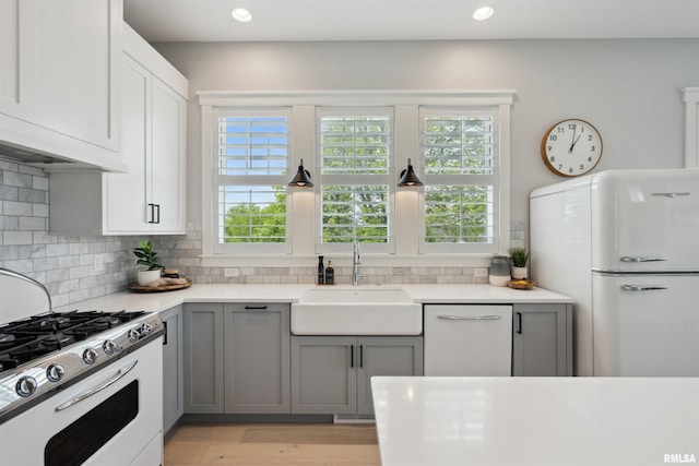 4691 Hidden Lake Ct, Bettendorf, IA 52722 - kitchen featuring white appliances, a sink, gray cabinets, tasteful backsplash, and recessed lighting