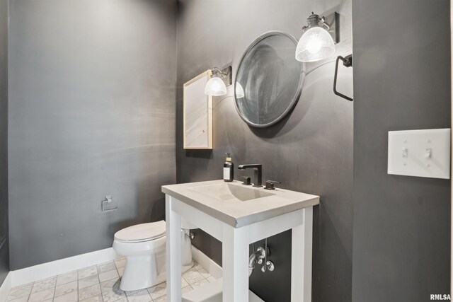 4691 Hidden Lake Ct, Bettendorf, IA 52722 - half bath featuring a sink, toilet, baseboards, and marble look tile flooring