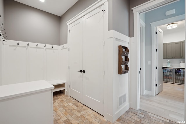 4691 Hidden Lake Ct, Bettendorf, IA 52722 - mudroom with wine cooler, brick patterned floors, recessed lighting, and baseboards