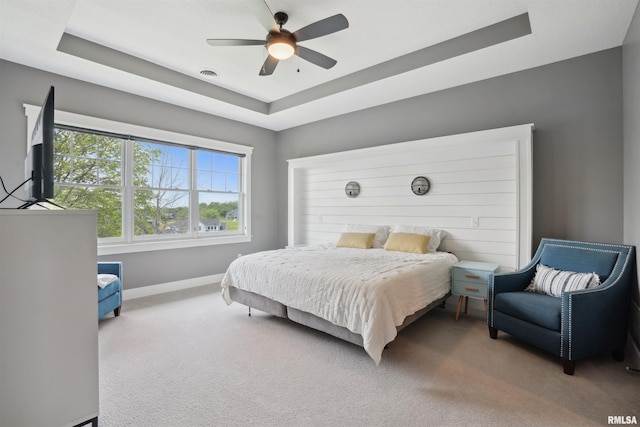 4691 Hidden Lake Ct, Bettendorf, IA 52722 - bedroom with a raised ceiling, baseboards, carpet floors, and a ceiling fan