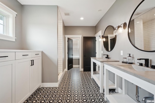 4691 Hidden Lake Ct, Bettendorf, IA 52722 - full bath featuring two vanities, baseboards, a shower, and recessed lighting