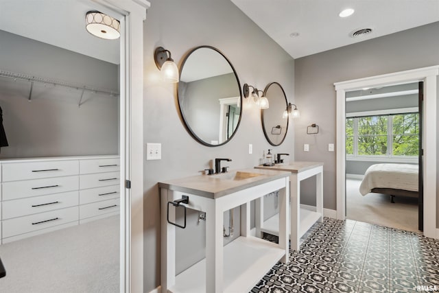 4691 Hidden Lake Ct, Bettendorf, IA 52722 - ensuite bathroom with baseboards, a sink, recessed lighting, and a spacious closet