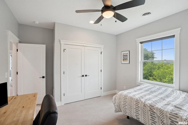 4691 Hidden Lake Ct, Bettendorf, IA 52722 - bedroom with light colored carpet, baseboards, a ceiling fan, and a closet
