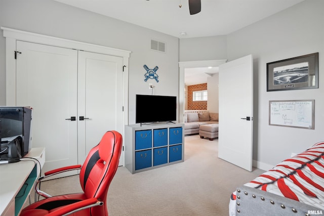 4691 Hidden Lake Ct, Bettendorf, IA 52722 - carpeted bedroom with a desk, ceiling fan, a closet, and baseboards