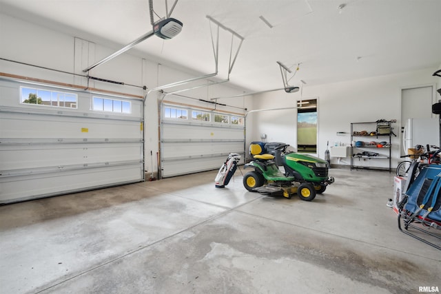 4691 Hidden Lake Ct, Bettendorf, IA 52722 - garage with a garage door opener and freestanding refrigerator