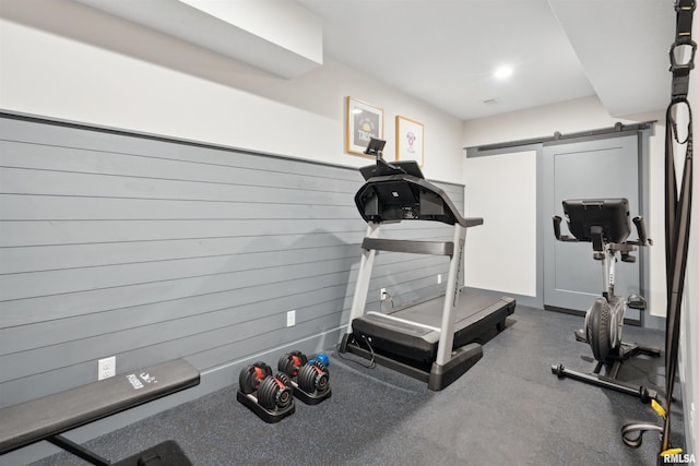 4691 Hidden Lake Ct, Bettendorf, IA 52722 - exercise room featuring a barn door