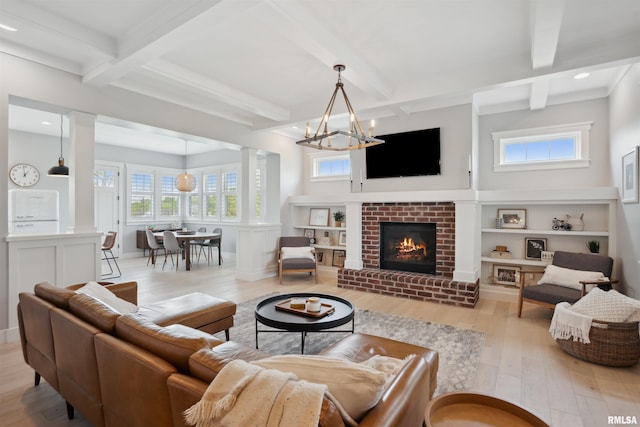 4691 Hidden Lake Ct, Bettendorf, IA 52722 - living area with ornate columns, light wood-style floors, coffered ceiling, a chandelier, and beamed ceiling