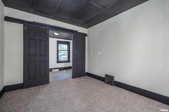1522 Bridge Ave, Davenport, IA 52803 - empty room with a barn door, carpet floors, and baseboards