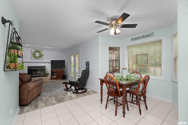 3513 33rd Street Ct, Moline, IL 61265 - dining area with baseboards, a glass covered fireplace, and ceiling fan