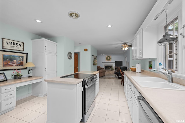 3513 33rd Street Ct, Moline, IL 61265 - kitchen with range with electric stovetop, a center island, a fireplace, a sink, and stainless steel dishwasher
