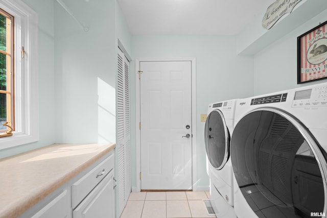3513 33rd Street Ct, Moline, IL 61265 - washroom with separate washer and dryer, light tile patterned floors, and cabinet space