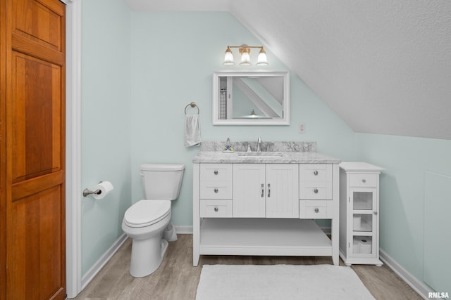 3513 33rd Street Ct, Moline, IL 61265 - bathroom with lofted ceiling, wood finished floors, vanity, toilet, and baseboards
