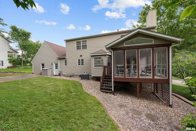 3513 33rd Street Ct, Moline, IL 61265 - rear view of property featuring a sunroom, a chimney, a lawn, and central AC