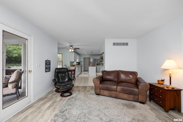 3513 33rd Street Ct, Moline, IL 61265 - living room featuring light wood-style floors, healthy amount of natural light, a ceiling fan, and baseboards