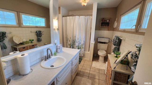 2606 4th Street Ct, East Moline, IL 61244 - bathroom featuring tile walls, tile patterned floors, vanity, and toilet
