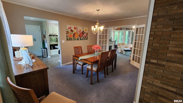 2606 4th Street Ct, East Moline, IL 61244 - dining area featuring a chandelier, baseboards, crown molding, and dark carpet