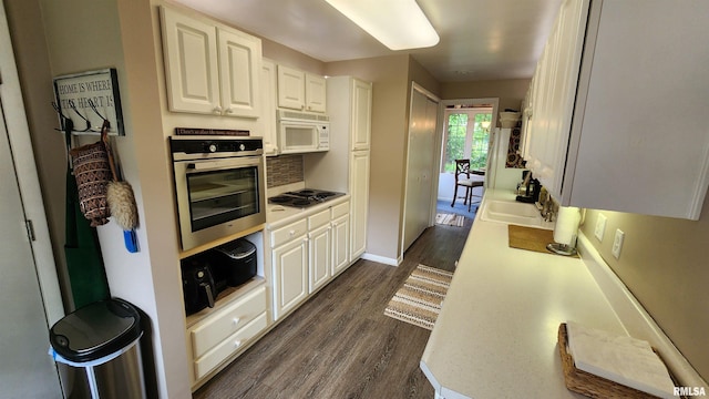 2606 4th Street Ct, East Moline, IL 61244 - kitchen featuring stainless steel oven, white microwave, electric cooktop, dark wood-style flooring, and a sink