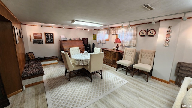 2606 4th Street Ct, East Moline, IL 61244 - dining area with light wood-type flooring, rail lighting, and baseboards