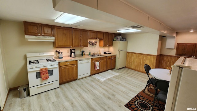 2606 4th Street Ct, East Moline, IL 61244 - kitchen featuring white appliances, under cabinet range hood, a sink, light countertops, and light wood finished floors