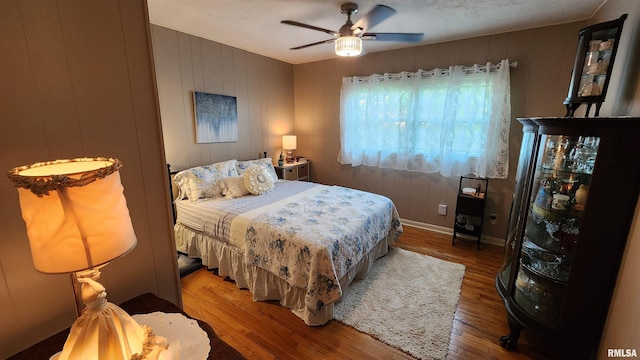 2606 4th Street Ct, East Moline, IL 61244 - bedroom featuring wood finished floors, a ceiling fan, and baseboards