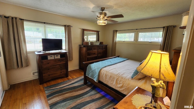 2606 4th Street Ct, East Moline, IL 61244 - bedroom featuring wood-type flooring, baseboards, ceiling fan, and a textured ceiling