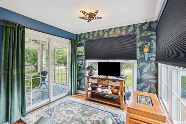 7318 35th Avenue Ct, Moline, IL 61265 - living room featuring wallpapered walls, wood finished floors, and baseboards