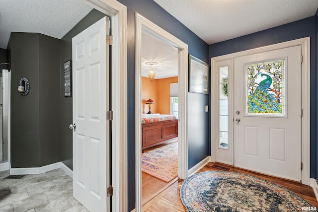 7318 35th Avenue Ct, Moline, IL 61265 - entryway featuring a textured ceiling and baseboards