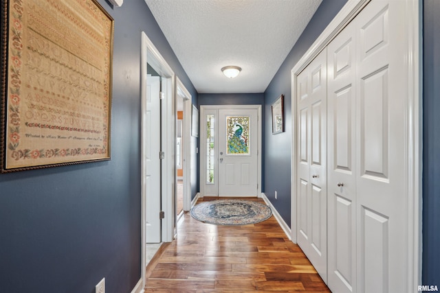 7318 35th Avenue Ct, Moline, IL 61265 - foyer featuring baseboards, wood finished floors, and a textured ceiling