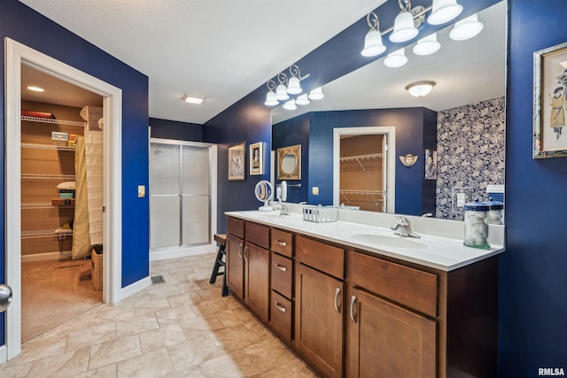 7318 35th Avenue Ct, Moline, IL 61265 - full bath featuring a spacious closet, double vanity, a stall shower, and baseboards