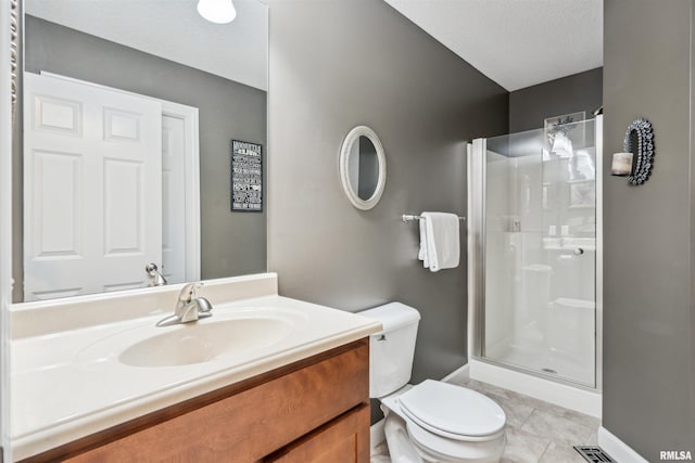 7318 35th Avenue Ct, Moline, IL 61265 - bathroom with toilet, a stall shower, vanity, tile patterned flooring, and baseboards