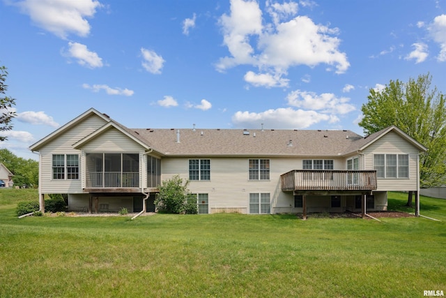 7318 35th Avenue Ct, Moline, IL 61265 - back of property featuring a sunroom, a deck, a lawn, and a shingled roof