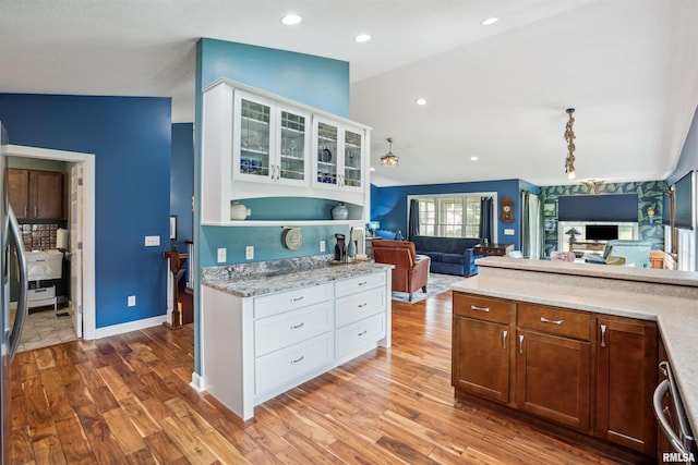 7318 35th Avenue Ct, Moline, IL 61265 - kitchen featuring glass insert cabinets, white cabinetry, light wood-type flooring, dishwashing machine, and vaulted ceiling