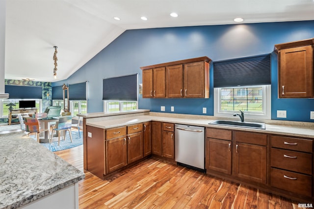 7318 35th Avenue Ct, Moline, IL 61265 - kitchen featuring stainless steel dishwasher, a sink, a peninsula, light wood-style floors, and high vaulted ceiling