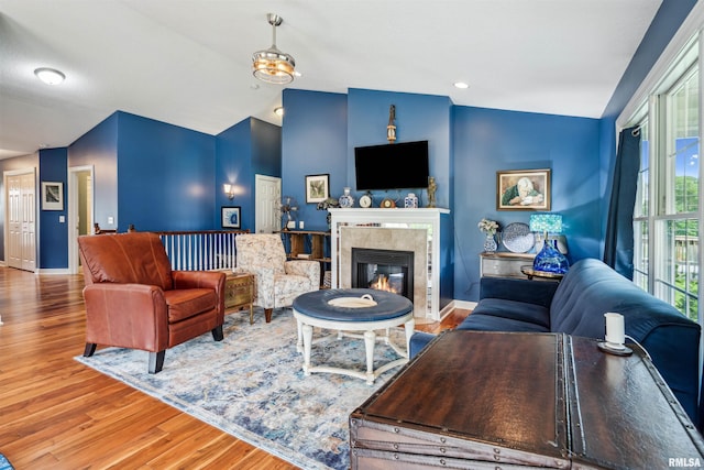 7318 35th Avenue Ct, Moline, IL 61265 - living room with vaulted ceiling, a fireplace, wood finished floors, and baseboards