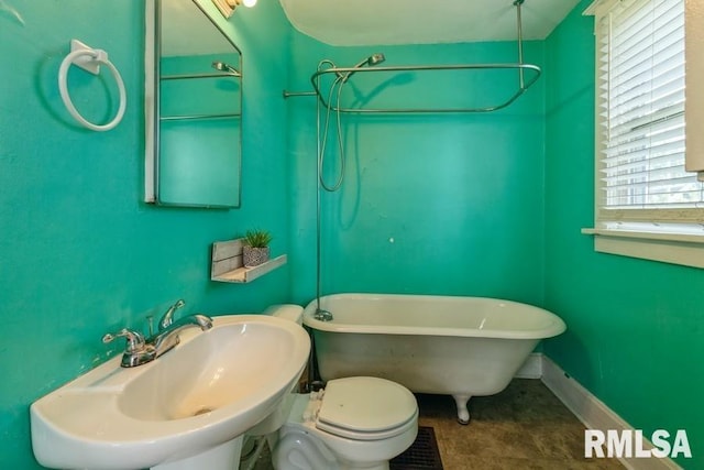 2308 18th Ave, Moline, IL 61265 - bathroom with a sink, baseboards, and a combined bath / shower with freestanding tub