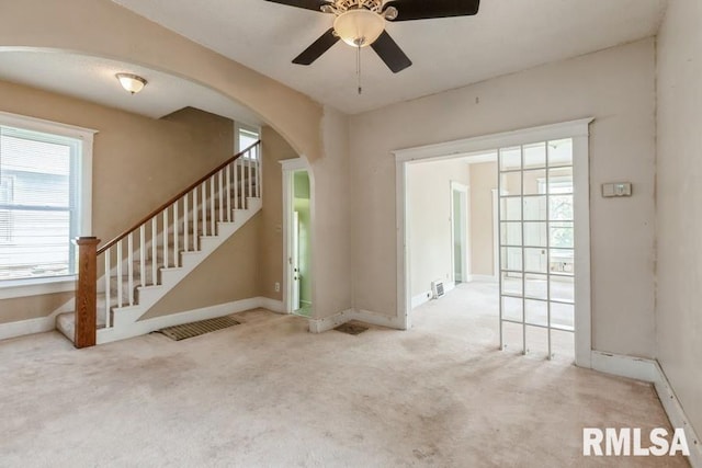 2308 18th Ave, Moline, IL 61265 - entrance foyer featuring arched walkways, ceiling fan, carpet, and baseboards