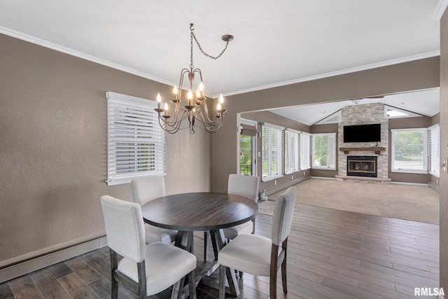 1872 19th Ave, Moline, IL 61265 - dining area featuring baseboard heating, lofted ceiling, dark wood-style floors, a chandelier, and a stone fireplace