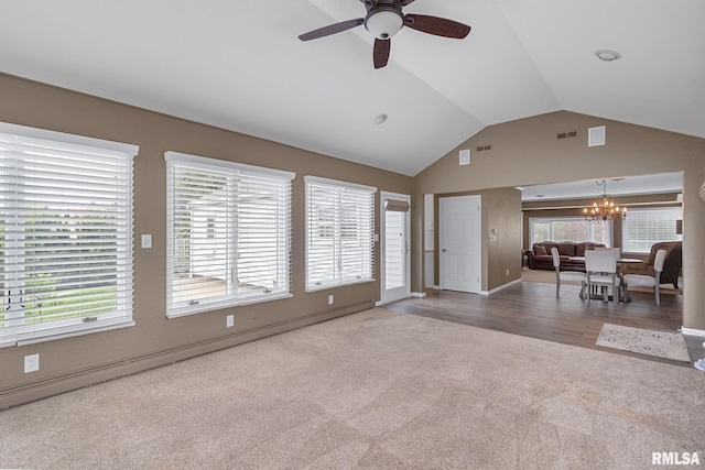 1872 19th Ave, Moline, IL 61265 - carpeted living area featuring a chandelier, a ceiling fan, vaulted ceiling, and healthy amount of natural light