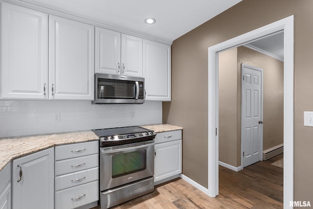 1872 19th Ave, Moline, IL 61265 - kitchen with stainless steel appliances, light wood-style flooring, backsplash, white cabinetry, and recessed lighting