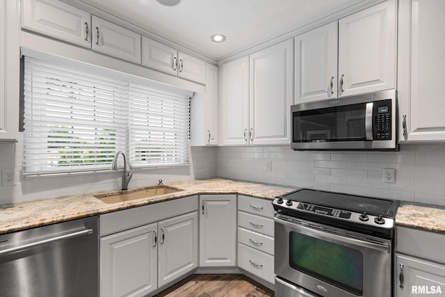 1872 19th Ave, Moline, IL 61265 - kitchen with stainless steel appliances, light wood-type flooring, tasteful backsplash, white cabinets, and recessed lighting