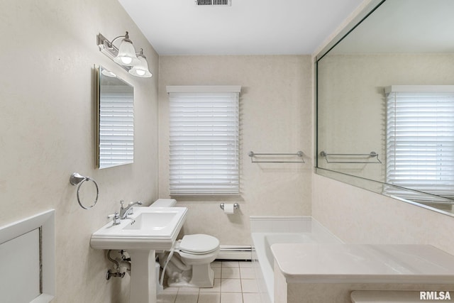 1872 19th Ave, Moline, IL 61265 - full bath with a baseboard heating unit, tile patterned flooring, and a tub to relax in