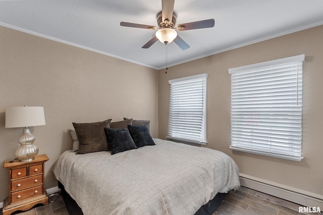 1872 19th Ave, Moline, IL 61265 - bedroom with baseboard heating, wood tiled floors, crown molding, and a ceiling fan