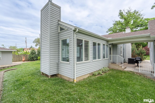 1872 19th Ave, Moline, IL 61265 - view of property exterior featuring a chimney and a central air condition unit