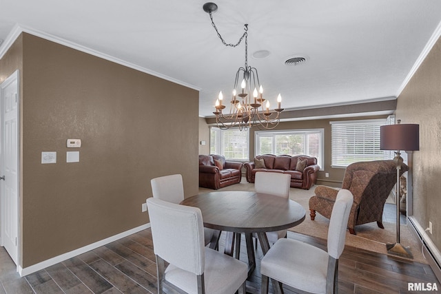 1872 19th Ave, Moline, IL 61265 - dining room featuring dark wood-type flooring, crown molding, a chandelier, and a baseboard heating unit