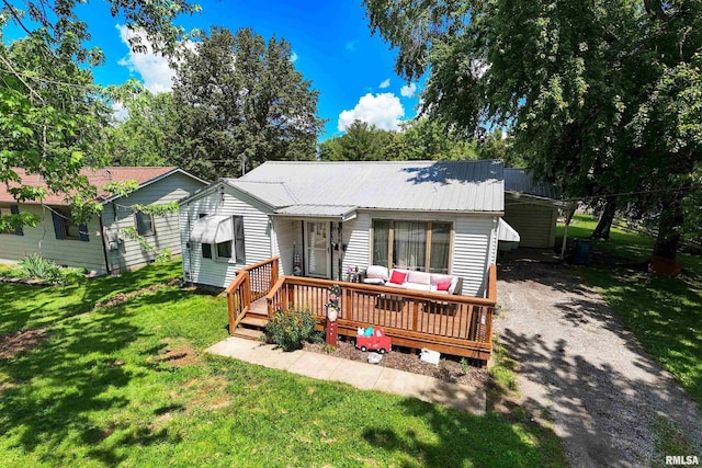 1013 Kirkpatrick St, Benton, IL 62812 - view of front facade featuring an outdoor living space, a deck, driveway, a front yard, and metal roof